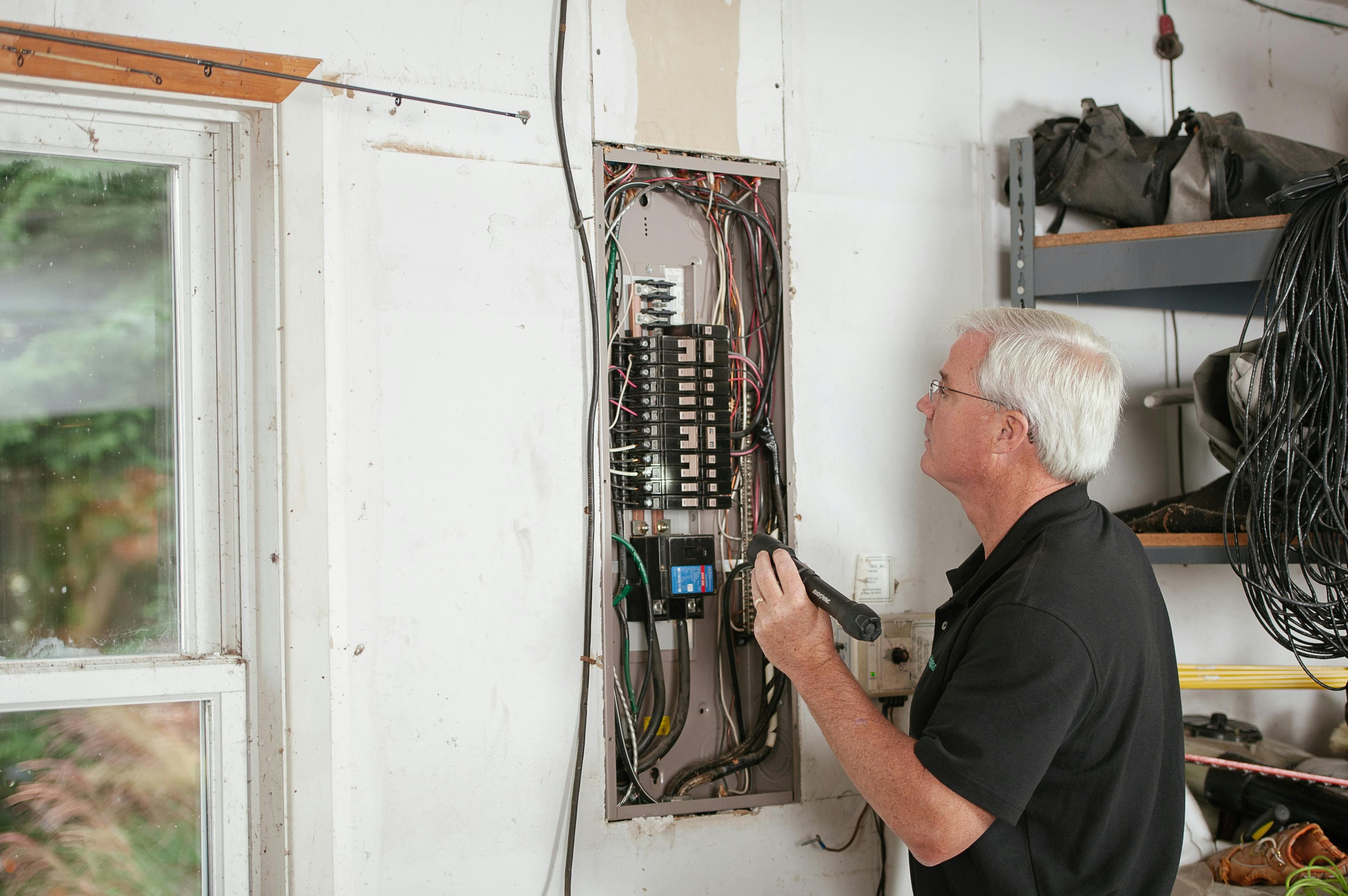 Electrician testing a residential electrical panel