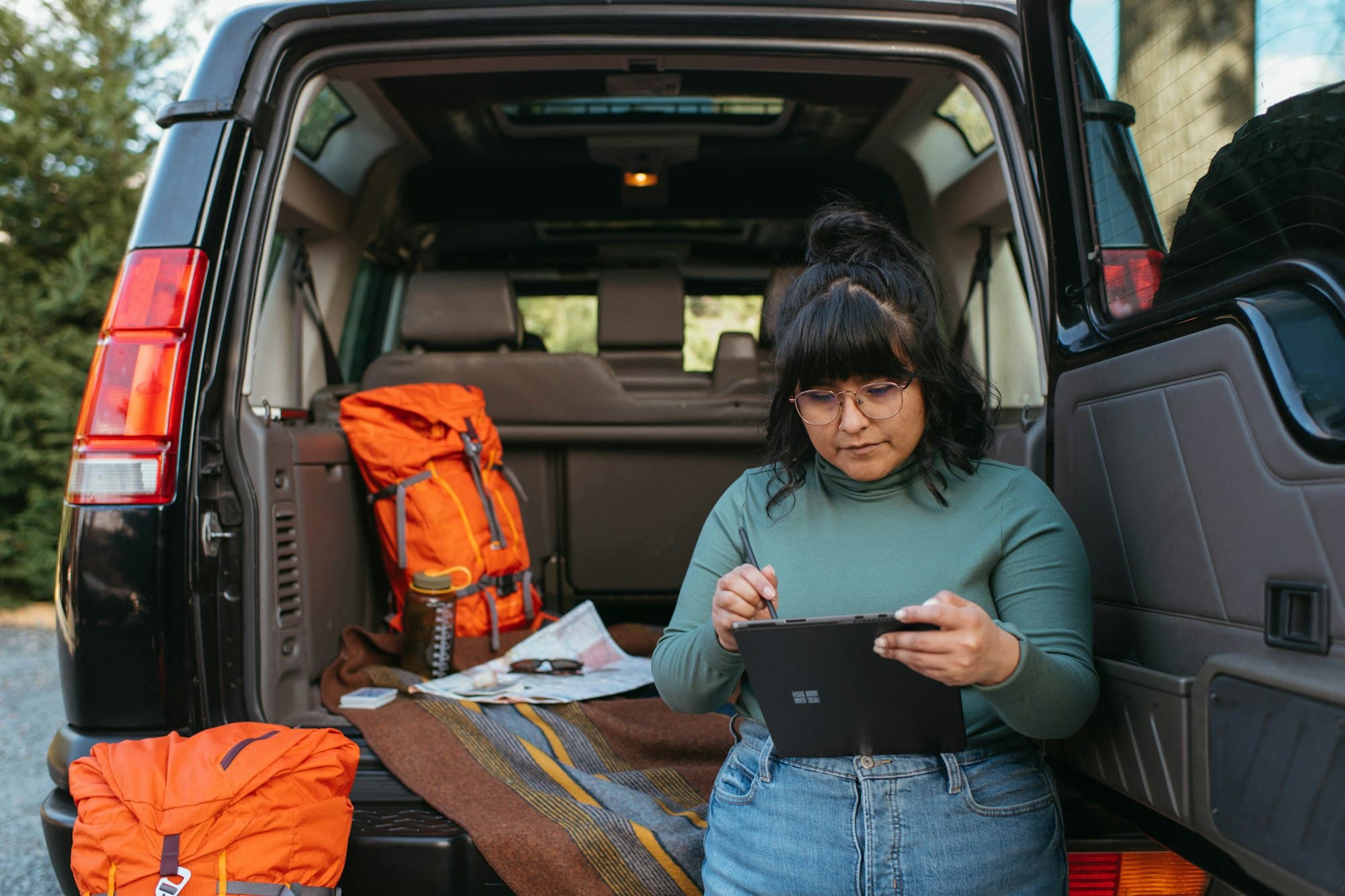 Service pro with a tablet at the back of a work van